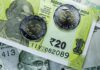 Indian Rupee Ends Flat Amid Importer Hedging and Global Tensions Indian currency: 20 Rupee notes and coins.