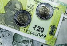 Indian Rupee Ends Flat Amid Importer Hedging and Global Tensions Indian currency: 20 Rupee notes and coins.